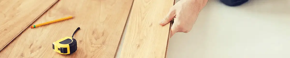 A professional installing wood flooring in Des Moines, IA