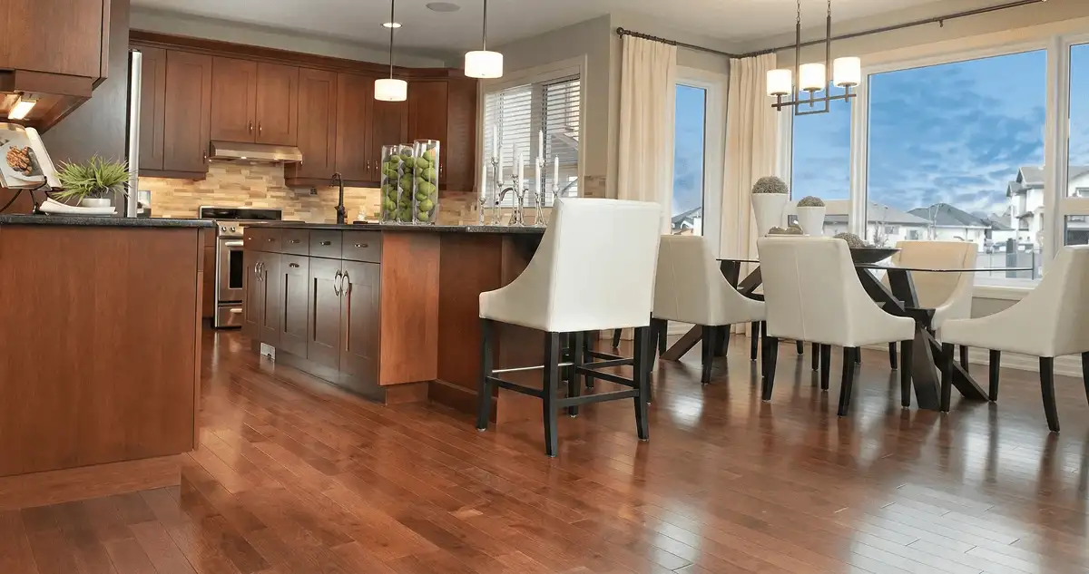 A modern kitchen with professionally installed wood flooring in Des Moines, IA