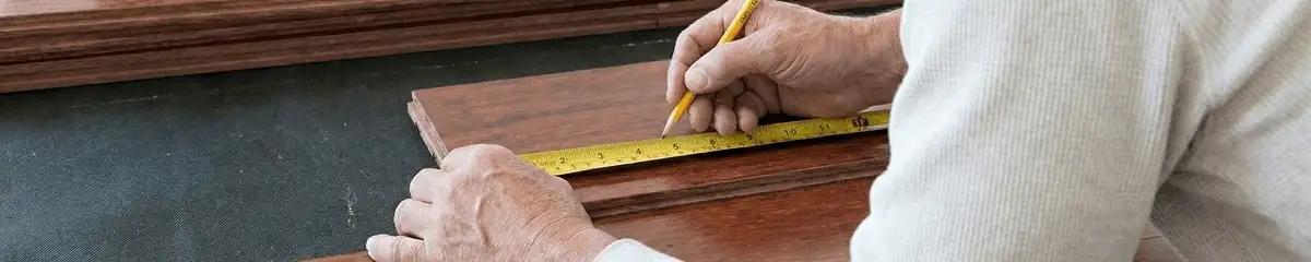 A professional installing wood flooring in Des Moines, IA